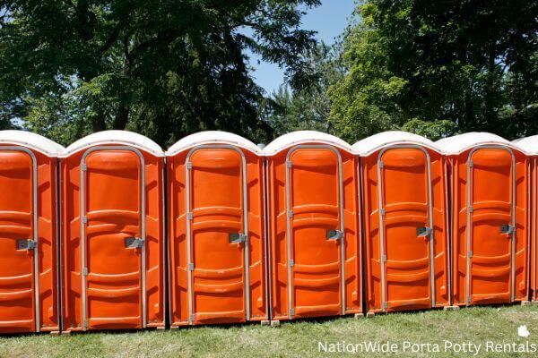 a lineup of clean and well-maintained portable loos for workers in Arco, ID